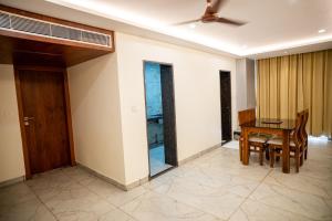a dining room with a table and chairs and a ceiling fan at Hotel The Pearl Shine in Gokarna
