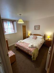 a bedroom with a large bed and a window at No 3 Mill Cote Cottage in Kingsbridge