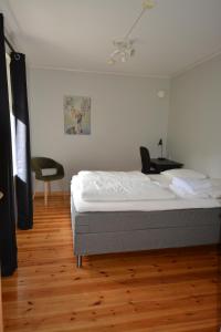a bedroom with a bed and a chair at Nesset Fjordcamping in Olden