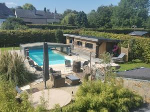 a swimming pool in a yard with a house at Le Cocoon du Curnolo in Namur