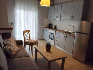 a kitchen and living room with a couch and a table at Fani House in Kallithea Halkidikis