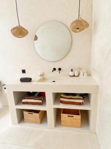 a bathroom with a sink and a mirror on the wall at Villa Wild & Free in Gili Trawangan