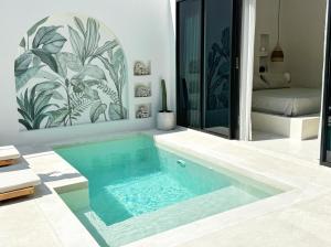 a swimming pool in the middle of a house at Villa Wild & Free in Gili Trawangan +10 photos