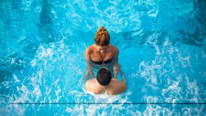 two women are in a pool of blue water at Hotel Excelsior - Liburnia in Lovran +37 photos
