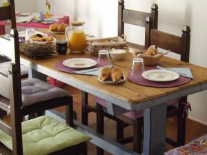 a wooden table with plates of food on it at B&B Il Gatto Pescatore in Stintino