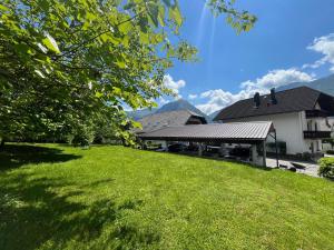 a green lawn in front of a building at Apartments and Rooms Tajcr in Bovec