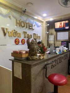 a hotel reception desk with a red stool in a room at Vuon Tao Dan Hotel - Trung Tâm Thành Phố Gần Chợ Bến Thành in Ho Chi Minh City