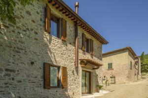 an old stone house with wooden windows and a street at Villetta Cafaggio, Ac, Wifi, Panzano In Chianti in Castellina in Chianti