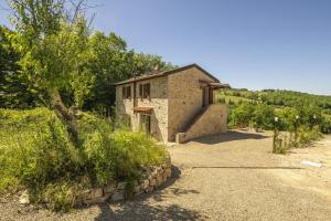 a small stone building with a tree in front of it at Villetta Cafaggio, Ac, Wifi, Panzano In Chianti in Castellina in Chianti +38 photos