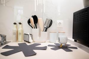 a counter with utensils and utensils at Cozy Boutique in Vrachati