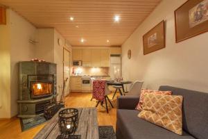 a living room with a couch and a fireplace at Kuukkeli Apartments Suite in Saariselka