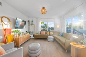 a living room with a couch and a table at Dream Stay! Pool, Hot Tub, PacMan,Foosball and More! in Oceanside