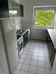 a small kitchen with a sink and a window at Moderne Monteurwohnung in der Nähe vom VW Werk 1 in Wolfsburg +2 photos