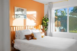 a bedroom with a white bed with a window at Dream Stay! Pool, Hot Tub, PacMan,Foosball and More! in Oceanside +152 photos