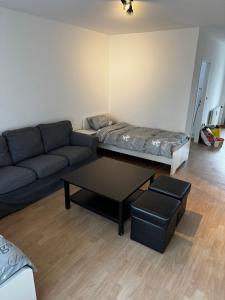a living room with a couch and a coffee table at Moderne Monteurwohnung in der Nähe vom VW Werk 1 in Wolfsburg