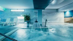 a large swimming pool with a tub in a house at Labranda Marieta & Spa - Adults Only in Playa del Ingles