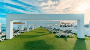 a row of lounge chairs and umbrellas on a balcony at Labranda Marieta & Spa - Adults Only in Playa del Ingles