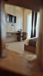a bedroom with a bed and a desk in it at The Corbett Green Woods in Rāmnagar