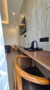 a kitchen with a table with a tea kettle on it at The Corbett Green Woods in Rāmnagar