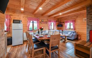 a kitchen and dining room with a table and a refrigerator at Villa Nina by Villas Guide in Ludbreg