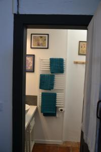 a bathroom with a white sink and green towels at Le Petit Couvent in LʼIsle-en-Dodon +37 photos