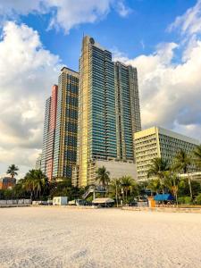 a view of some tall buildings on a beach at Elegant 2BR Manila Bay Sunset near US Embassy in Manila