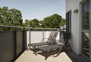 two chairs on the balcony of a house at Quality Hotel Visby in Visby