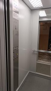 a hallway with a shower and a glass door at Orbeli Apartment in Aghk'ilisa