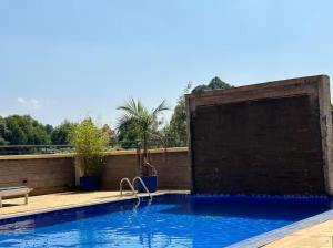 a swimming pool with a water feature in a backyard at The Cozy house in Nairobi