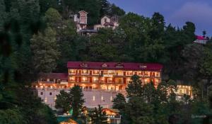 a hotel on the side of a mountain at night at Pax Hotel Spring Solance 200 mtr from Gandhi Chowk Khajjiyar Road in Dalhousie