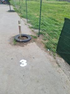 a number painted on the ground next to a fence at Latin studio in Bragadiru