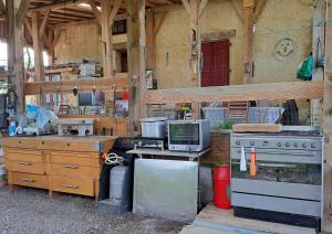 a kitchen with a stove and a stove top oven at ENTRE ADOUR et MONTAGNE in Pouillon +35 photos