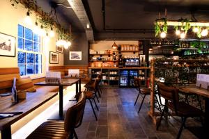 a restaurant with tables and chairs in a room at Rock Mill Studio Apartment 9 in Stoney Middleton