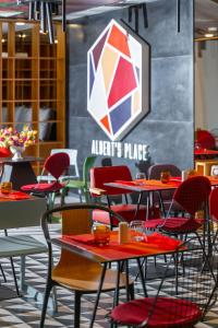 a restaurant with red chairs and tables and a large puddle at ibis Bucharest Politehnica in Bucharest