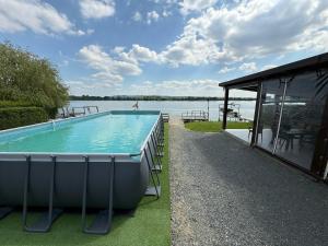 a swimming pool with a view of the water at Fishing Trip Divici in Divici