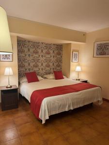 a bedroom with a large bed with red pillows at A Casitta 2 Luxury Apartments in Taormina