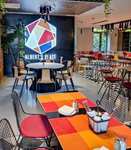 a restaurant with tables and chairs and a colorful rug at ibis Bucharest Politehnica in Bucharest