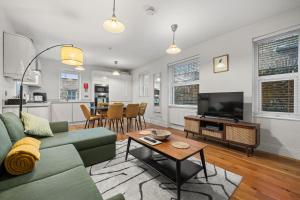 a living room with a couch and a tv and a table at Brand NEW 2 BR Fulham Apartment Near Tube Station COZY in London