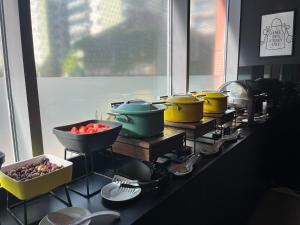 a kitchen with several pots and pans on a counter at ibis Bucharest Politehnica in Bucharest