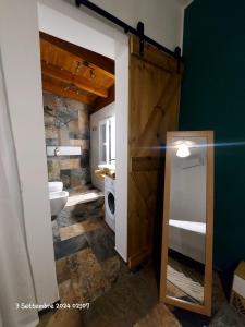 Un baño con lavabo, inodoro y puerta. en Agrivilla Holiday Vacation Home, en Padresergio