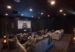 a room with couches and a screen with a presentation at FV PEPPERS Luxury City Apartment in Brisbane