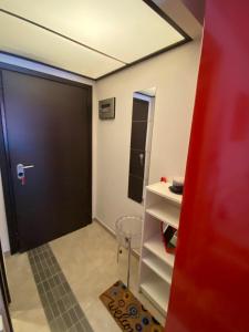 a room with a door and a table and a chair at Anastasia's cozy studio in Nea Plagia