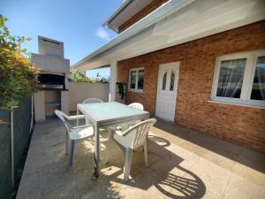 a patio with a white table and two chairs at Casamilia Suite Parentale in Esposende
