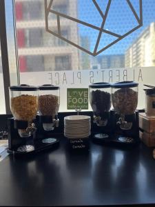 a table with three containers of oatmeal on it at ibis Bucharest Politehnica in Bucharest