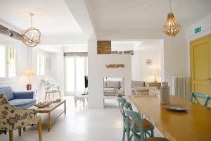 a kitchen and living room with a table and chairs at Terramare Villa's 4 in Kithnos