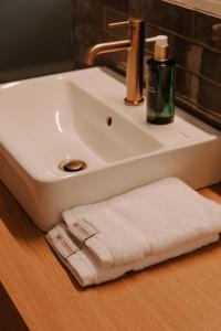 a bathroom sink with a white towel on a counter at Colliemolenhoeve 
