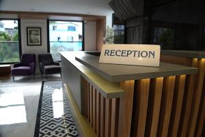 a reception counter with a sign that reads reception at Happy Apart Hotel in Kuşadası +31 photos