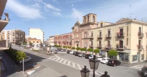 a view of a city street with buildings and cars at Al Carmine Rooms in Milazzo
