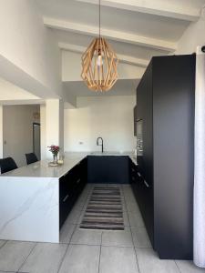 a kitchen with a black and white counter and a sink at WonderFarm2point0 Oran villa 10 people in Oran