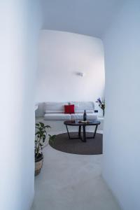 a living room with a white couch and a table at Santonero in Akrotiri